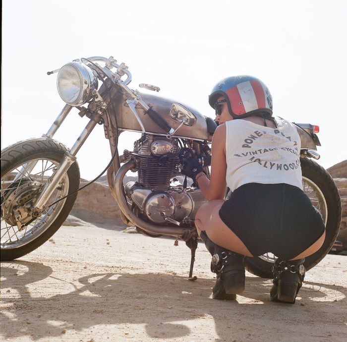 A playful frame from Girls on a motorcycle — online in Duning